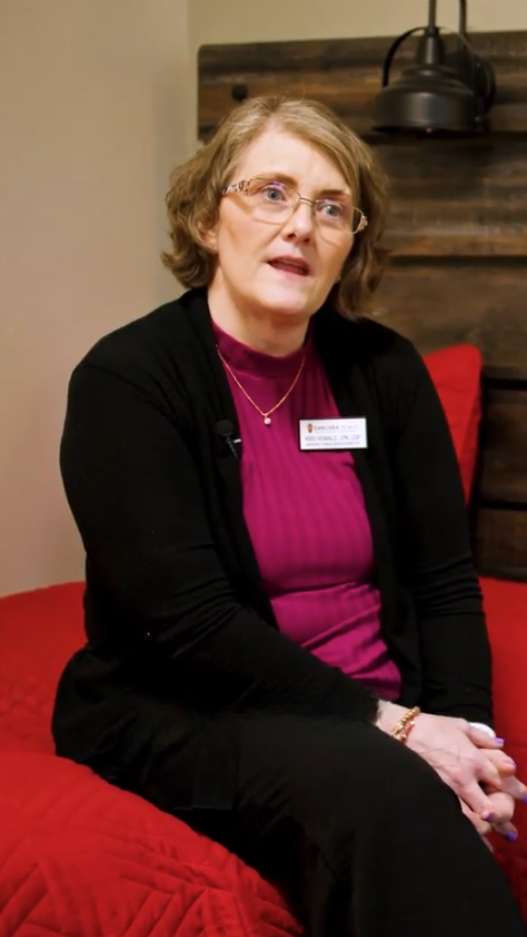 woman in black cardigan and pink undershirt