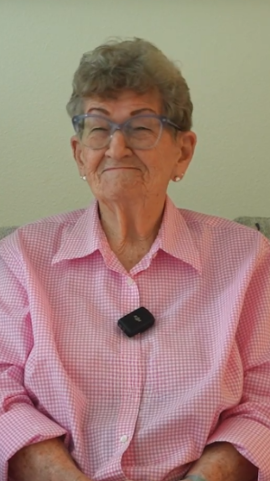 senior woman in pink plaid shirt