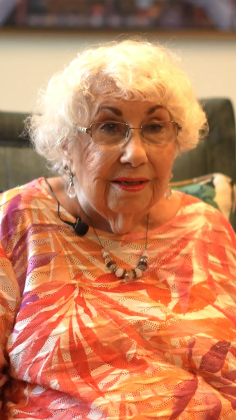 Senior woman in orange tropical shirt