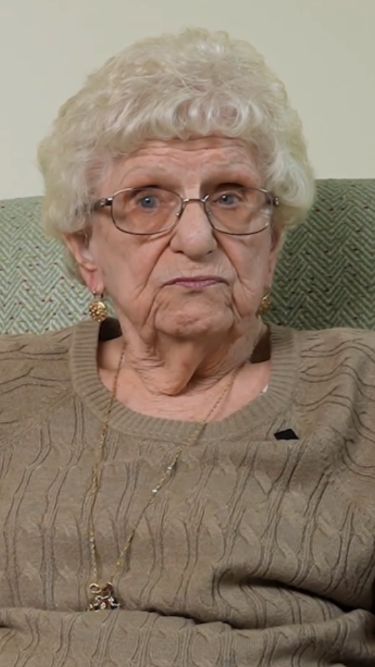 Senior woman in brown grey sweater