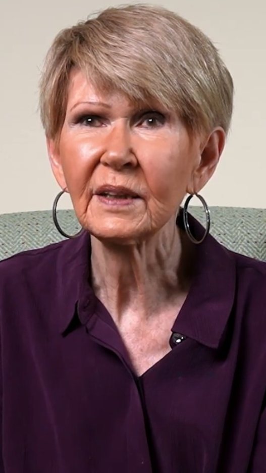 senior woman in purple button down