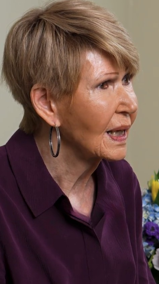 senior woman in velvet purple button down